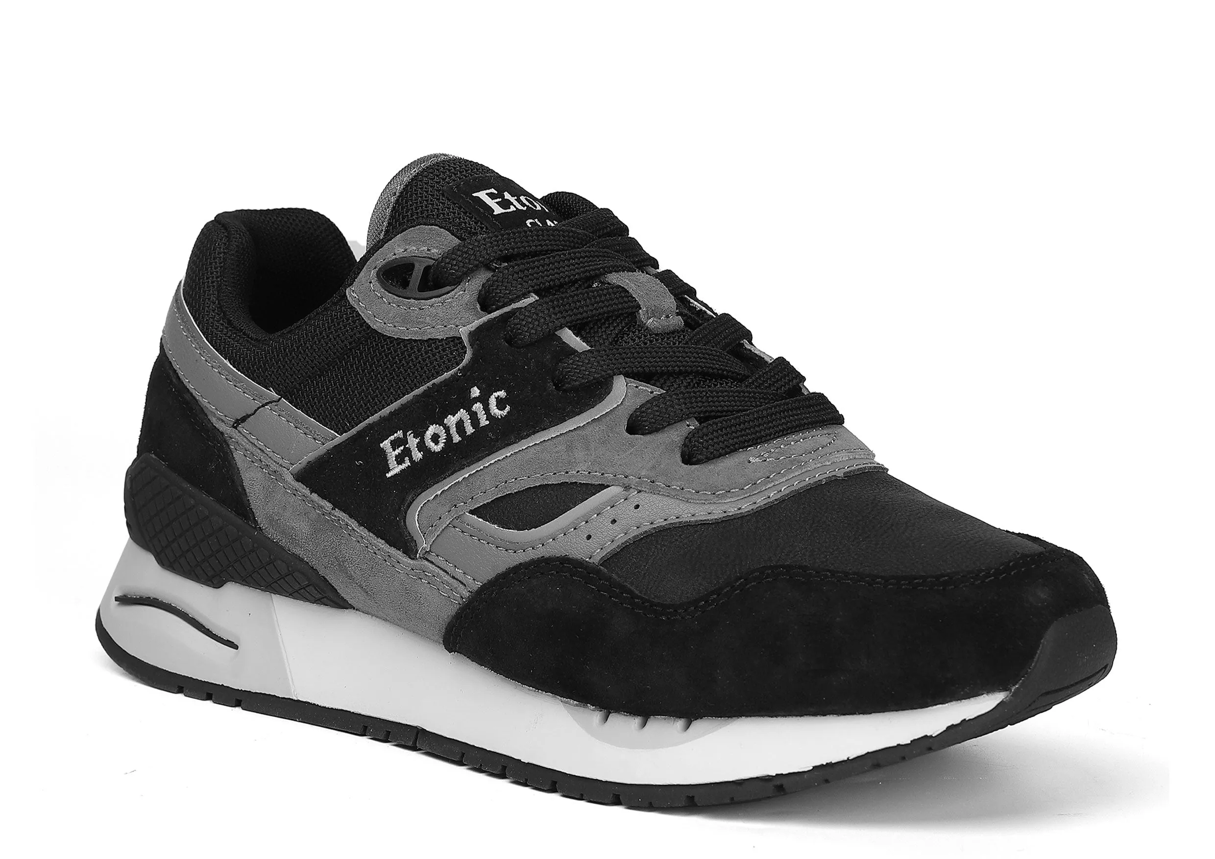 Etonic Stable Base sneakers in black nubuck, tonal mesh fabric, black suede with multi-layer dark grey leather inserts, white midsole and black bottom outsole.