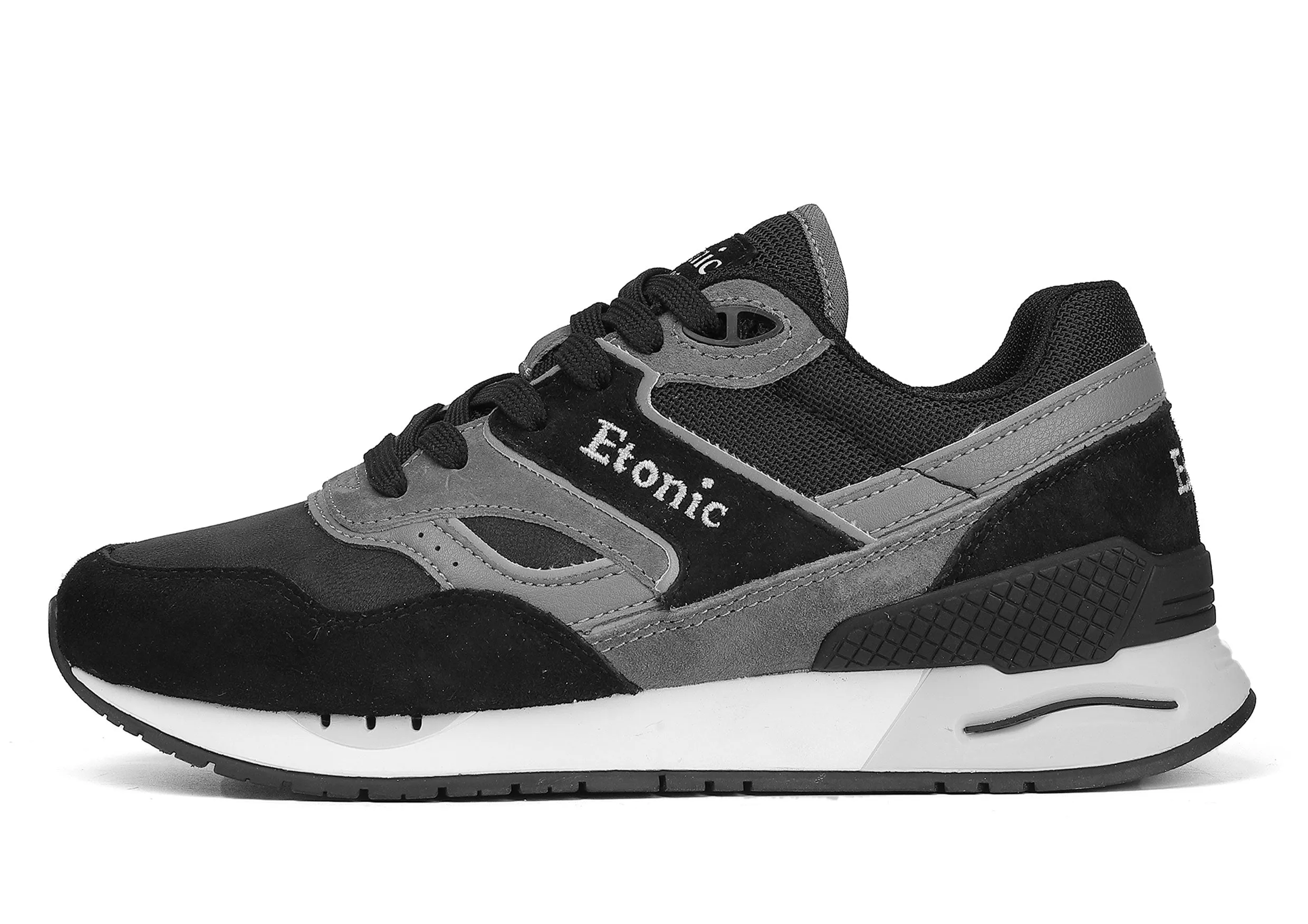 Etonic Stable Base sneakers in black nubuck, tonal mesh fabric, black suede with multi-layer dark grey leather inserts, white midsole and black bottom outsole.