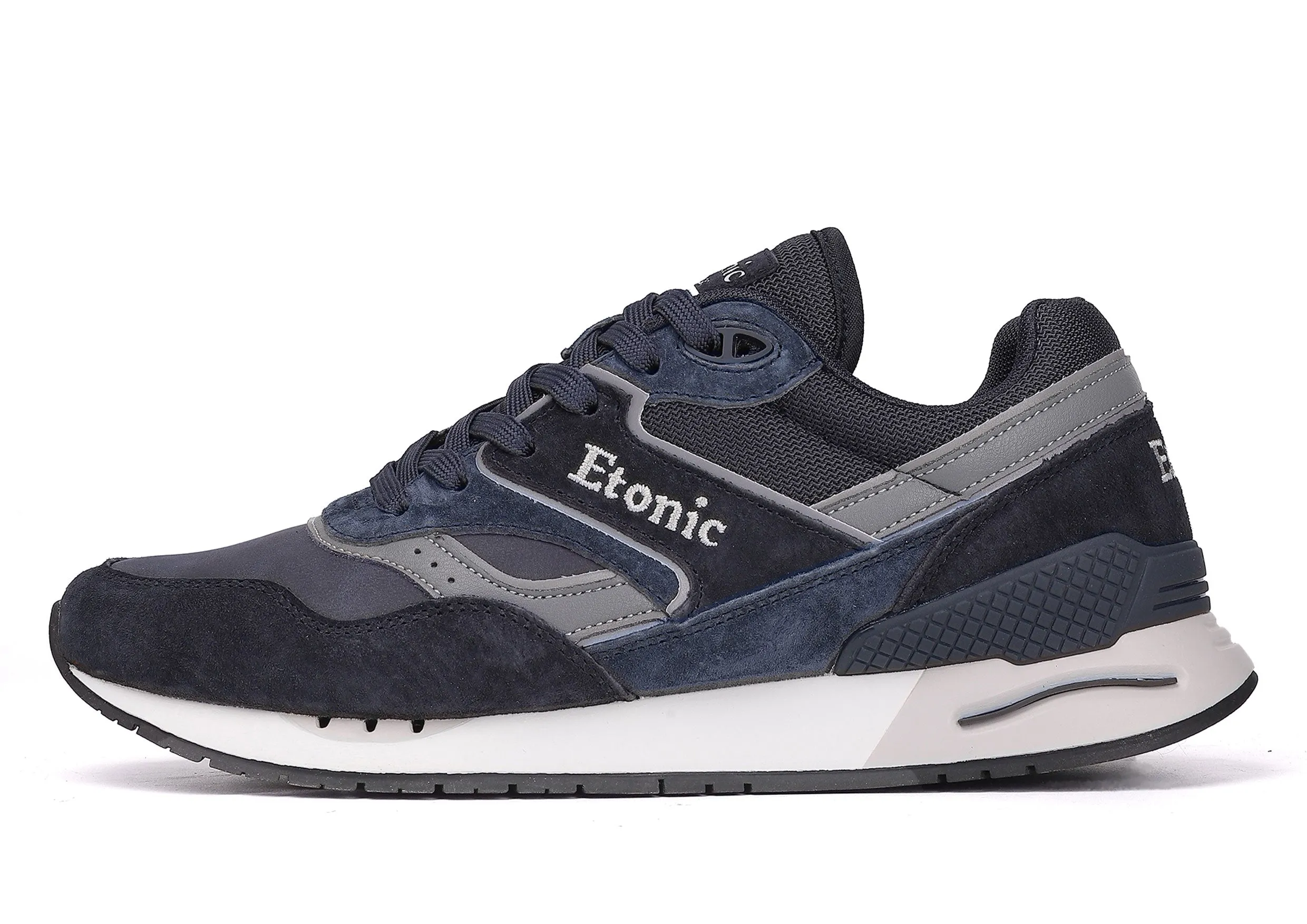 Etonic Stable Base sneakers in dark blue nubuck, tonal mesh fabric, dark blue suede with multi-layer grey leather inserts, white midsole and dark blue bottom outsole.